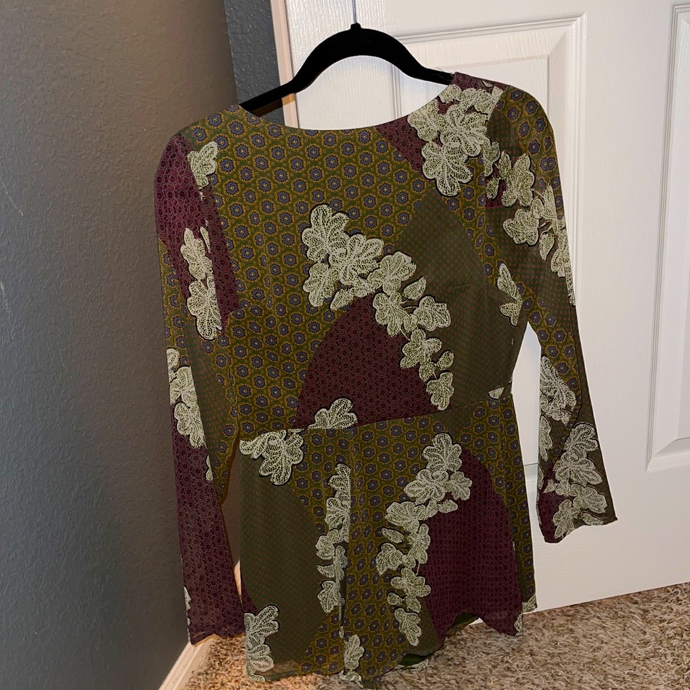 Pretty green and purple romper with flower detail